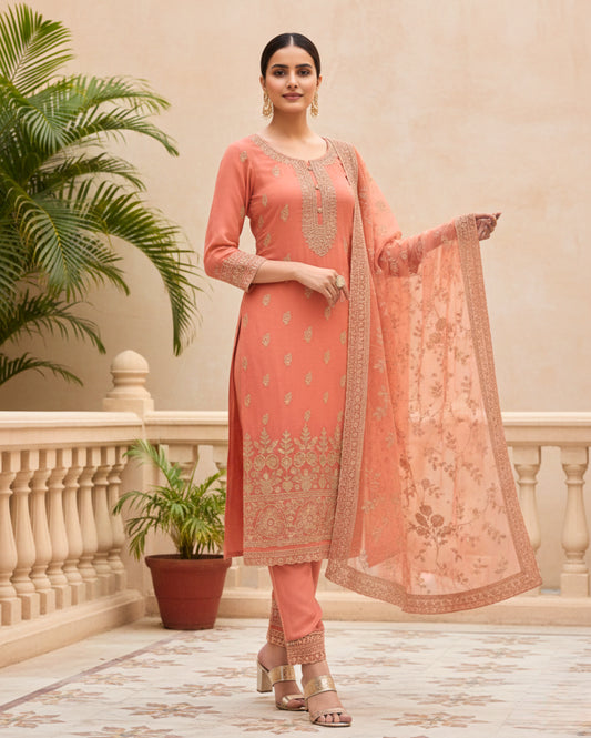 Semi-stitched peach cotton suit featuring delicate pastel thread and subtle sequin embroidery. The kurta is adorned with elegant motifs and a finely detailed hem border, paired with matching bottoms and a lightweight embroidered dupatta.