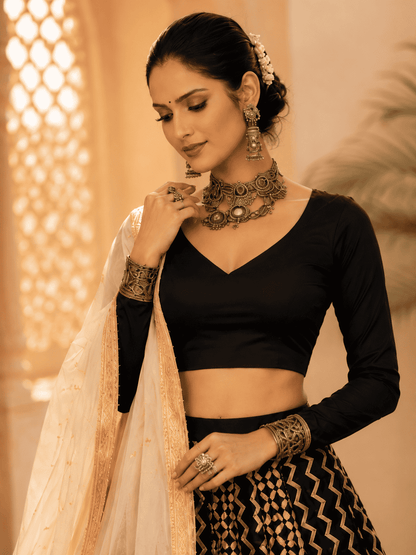 Black cotton silk blouse with ivory geometric printed gota lace lehenga paired with an ivory embroidered organza dupatta